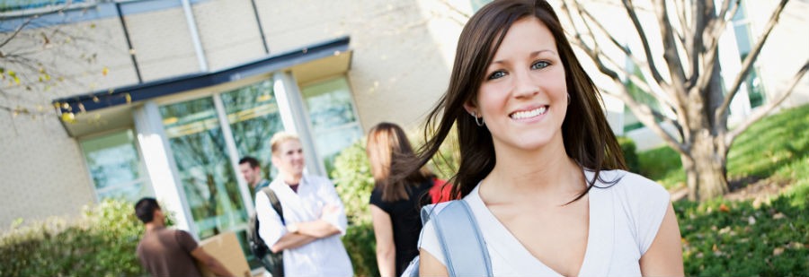 Here are some moving tips for college students - female college student carrying a box